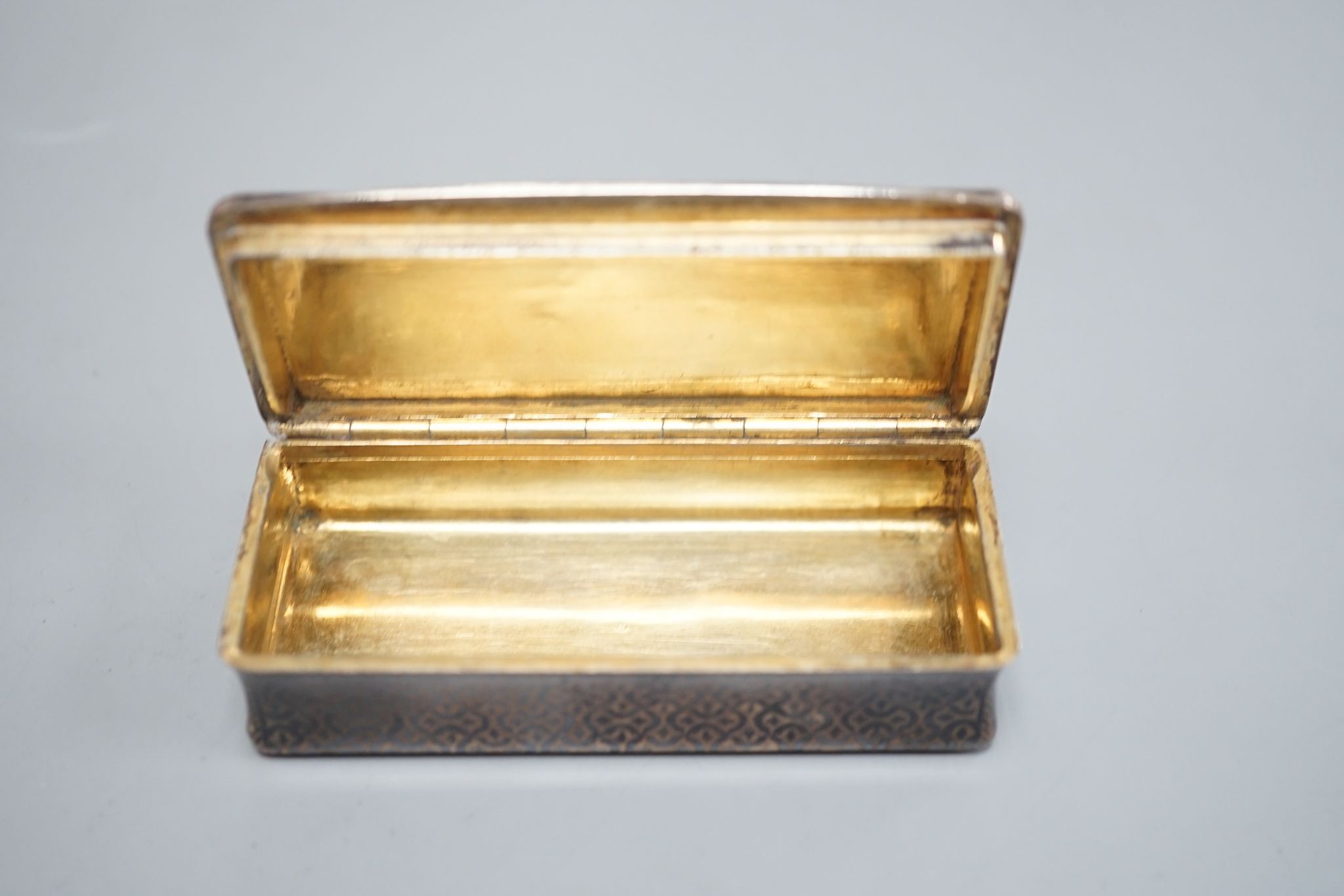 A 19th century French white metal and niello snuff box, 78mm, decorated with hunting scene.
